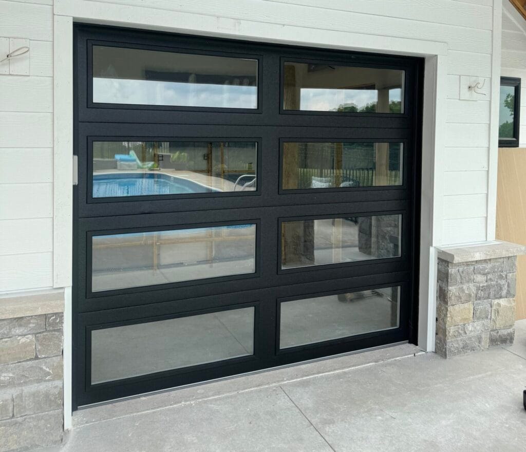 Full-view black aluminum and glass garage door installed in Lexington KY