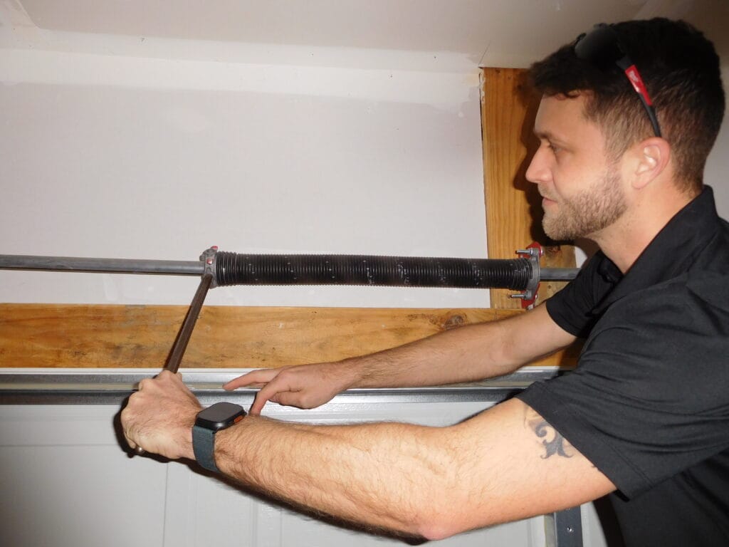 Bo Pittman working on a garage door opener rail