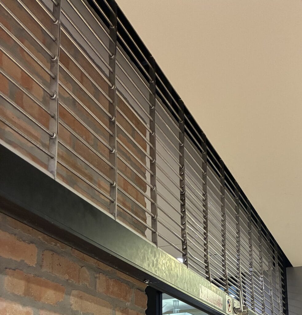 Mall storefront rolling security grille above a retail entrance